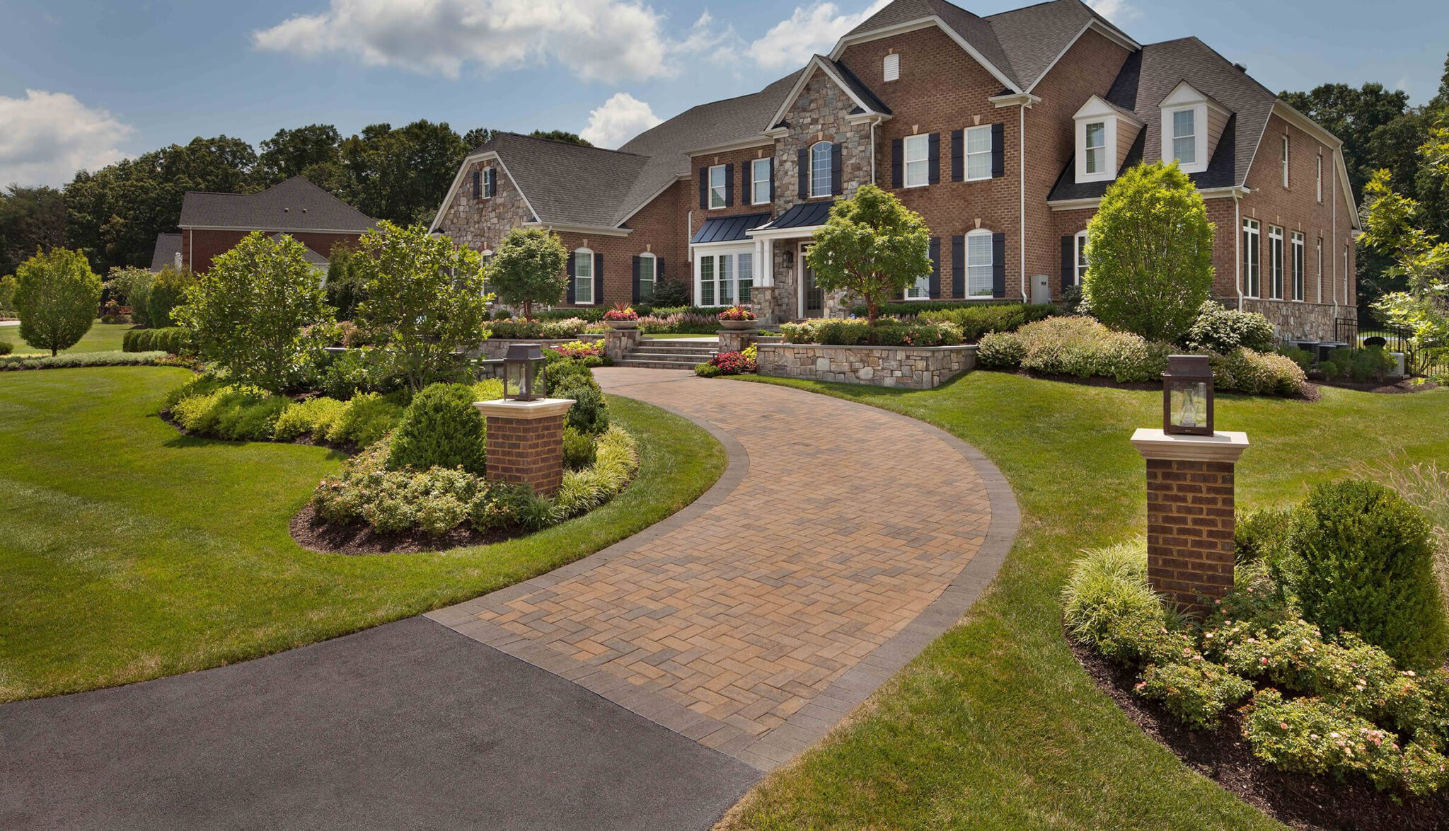 a half circle driveway design with colorful tumbled pavers
