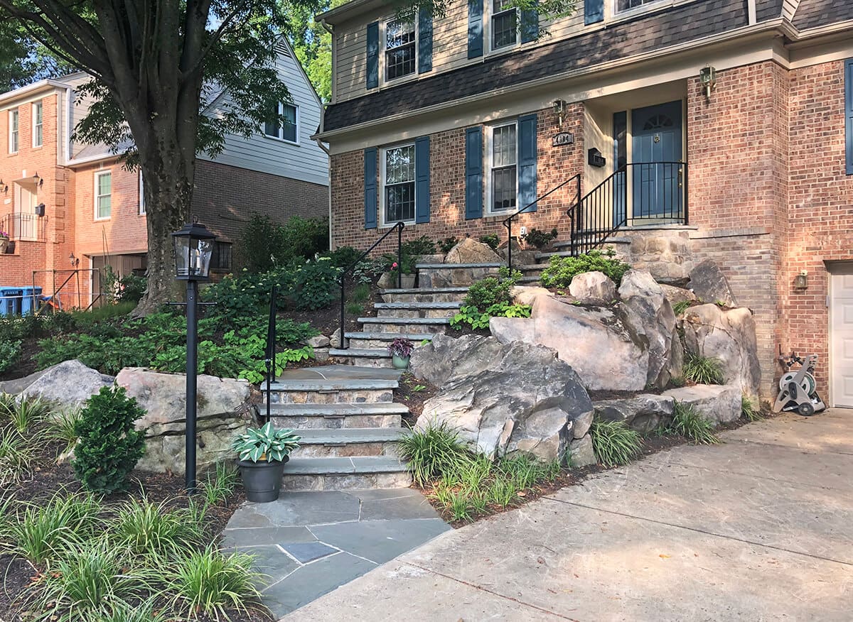 smal front yard landscape with boulder retaining wall