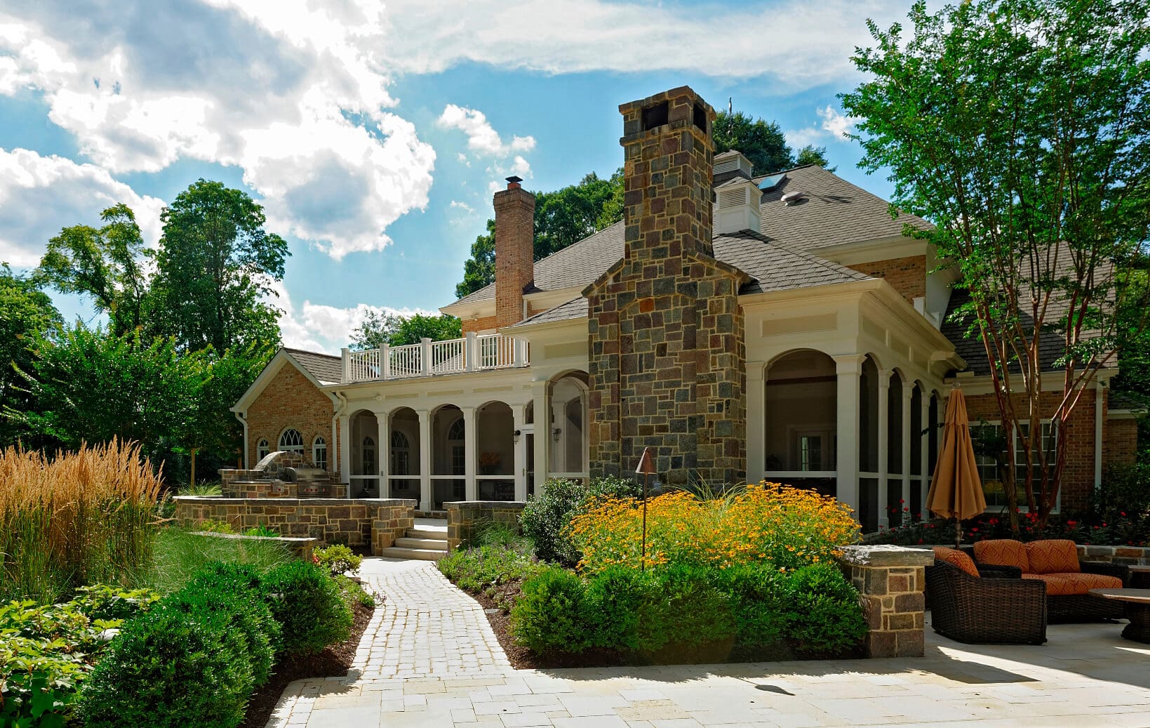 wildflowers along cobblestone walkway in Greats backyard